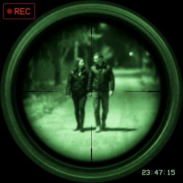 View through surveillance lens focusing on a distant subject